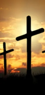 Silhouetted crosses against a vibrant sunset sky, perfect for mobile.