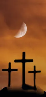 Three black crosses under a half-moon against an orange dusk sky.