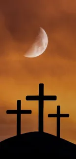 Three crosses silhouetted against an orange sky with a crescent moon.