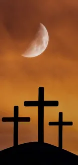 Three crosses silhouetted against an orange sky with a moon above.