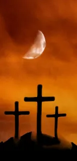 Three crosses silhouetted against an orange sky with a crescent moon.