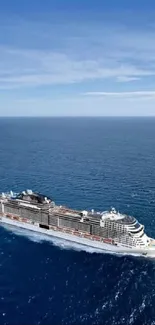 Elegant cruise ship sailing on a calm, deep blue ocean under a bright sky.