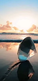 Glowing crystal on the beach with sunset reflections over ocean waves.