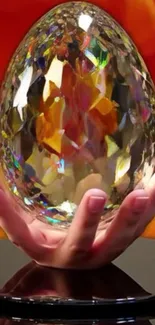 Hand holding a colorful crystal egg with vibrant background.