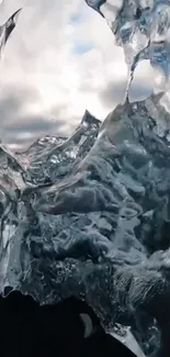 Abstract ice formation with cloudy sky backdrop.