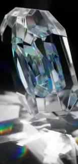 Faceted crystal with rainbow reflections on a black background.
