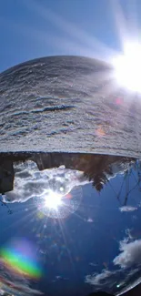 Reflective crystal sphere with bright sky and landscape.