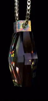 Elegant crystal pendant on dark background.