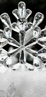 Crystal snowflake resting on white snow background.