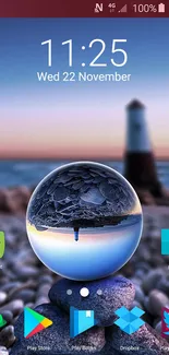 Mobile wallpaper with a crystal sphere and blurred lighthouse at the beach.