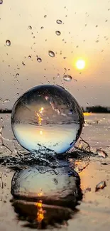 Crystal sphere splashes water as sun sets, reflecting warm orange and yellow hues.