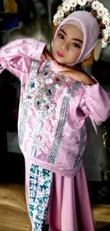 Child in elegant traditional attire posing gracefully.