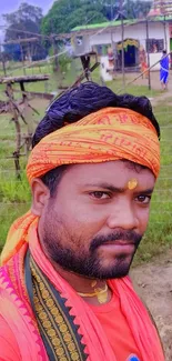 Vibrant cultural attire with rural background.