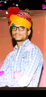 Young man with a vibrant traditional turban and cultural attire.