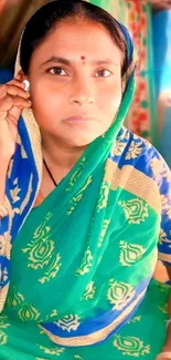 Woman in vibrant green saree looking intently.