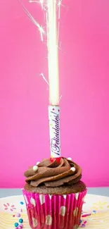 Cupcake with sparkler on pink background, vibrant and festive mobile wallpaper.