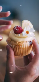 Cupcake with lemon slice and flower in hand, perfect for a mobile wallpaper.