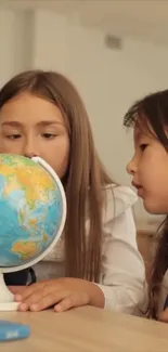 Two kids curiously exploring a globe in a classroom setting.