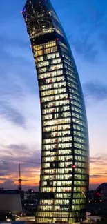 Curved skyscraper against dusk sky with city lights.