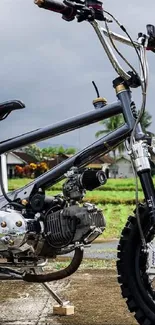 Custom mini bike on a scenic road with a cloudy sky.