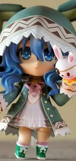 Anime figure with green hood and plush bunny, blue hair.