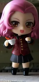 Cute anime figurine with pink hair holding a cup.