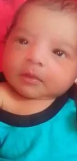 Cute baby in blue outfit with red background wallpaper.