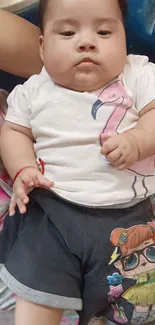 Adorable baby in cartoon-themed outfit