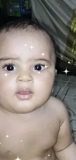 Cute baby with sparkling eyes and background effect.