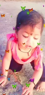 Cute baby surrounded by colorful butterflies outdoors.