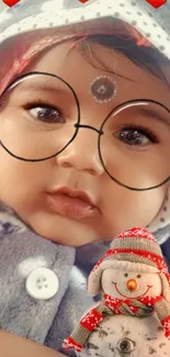 Adorable baby in glasses with snowman theme mobile wallpaper.