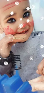 Adorable baby with snowflakes and face paint, smiling brightly.