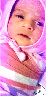 Adorable baby wrapped in pink with sparkling effect.