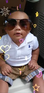 Cute baby wearing sunglasses with colorful hearts and stars around.