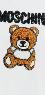 Cute embroidered teddy bear on white background wallpaper.