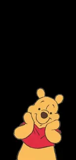 Adorable yellow bear in red shirt on black mobile wallpaper.