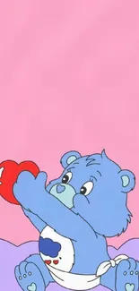 Cute blue bear reaching for a red heart on a pastel pink background.