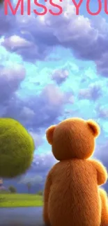 Teddy bear gazing at a blue sky with fluffy clouds.