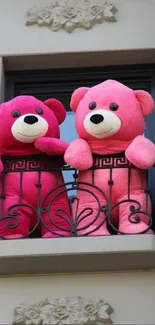 Two pink teddy bears on a balcony, enjoying a scenic view.