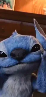 Playful blue alien in a cozy room setting.