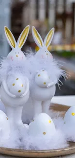 Adorable white bunnies and Easter eggs on a decorative plate.