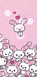 Cute cartoon bunnies with hearts on a pink background.