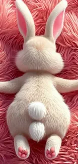 Cute bunny resting on pink fluffy fur.