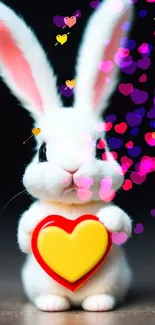 White bunny holding a heart on a dark background.