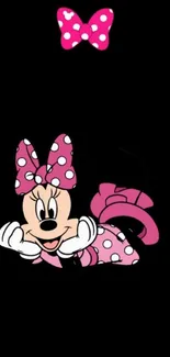 Cartoon character with pink polka dots on a black background.