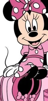 Cute cartoon character in pink attire sitting on a suitcase.