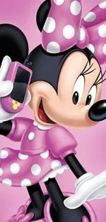 Cheerful cartoon character with pink polka dot dress and bow holding a mobile phone.