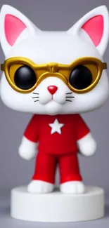 Cute cat figure with sunglasses and red outfit on gray background.