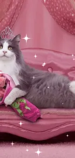 Fluffy grey and white cat lounging on a pink sofa with roses.