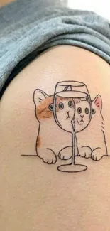 Cartoon cat tattoo with wine glass on arm.